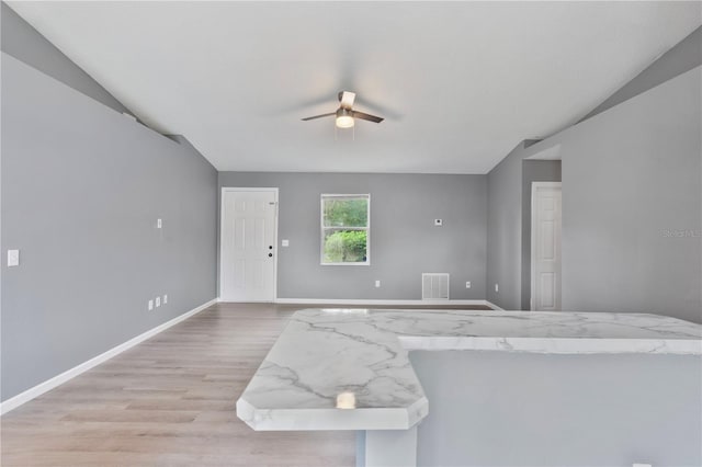 living room with ceiling fan, light hardwood / wood-style flooring, and lofted ceiling