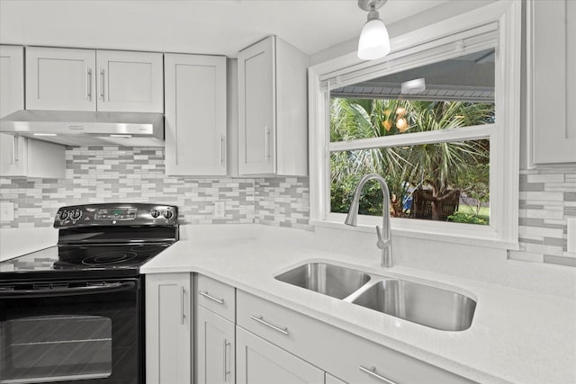 kitchen featuring sink, ventilation hood, black electric range, white cabinetry, and tasteful backsplash