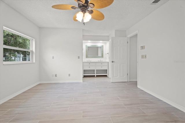 unfurnished bedroom featuring ceiling fan, a textured ceiling, and light hardwood / wood-style flooring