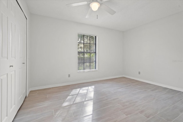 unfurnished bedroom with a textured ceiling, light wood-type flooring, a closet, and ceiling fan