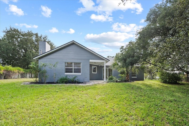 back of property featuring a lawn