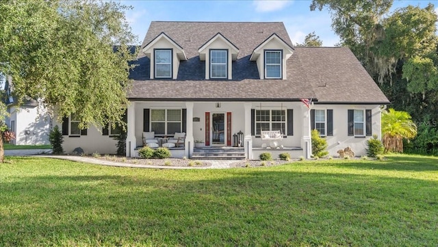 cape cod-style house featuring a front lawn and a porch