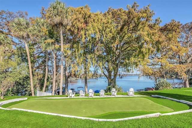 view of property's community with a yard and a water view