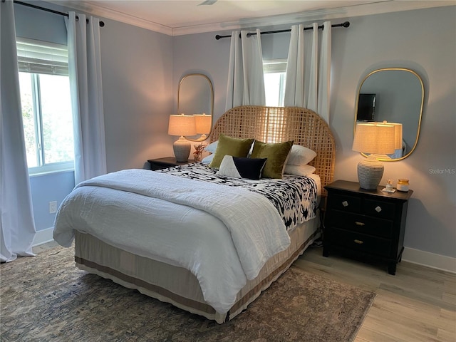 bedroom with hardwood / wood-style floors and crown molding