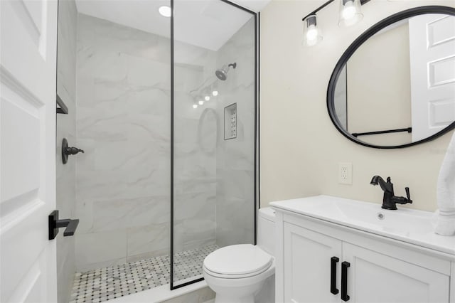 bathroom featuring toilet, vanity, and walk in shower