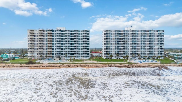 view of property featuring a water view and a view of the beach