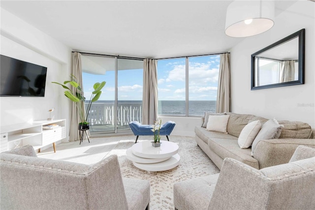 living room featuring floor to ceiling windows and a water view