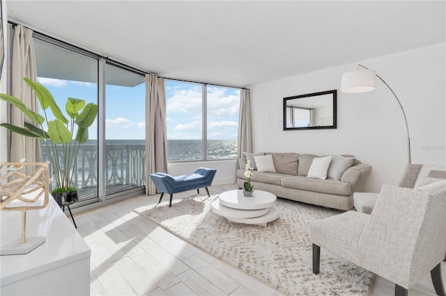 living room with floor to ceiling windows and a water view