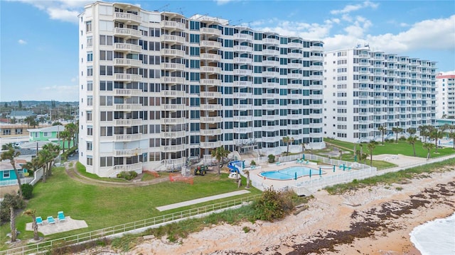 view of building exterior featuring a community pool