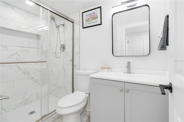 bathroom featuring vanity, toilet, and an enclosed shower