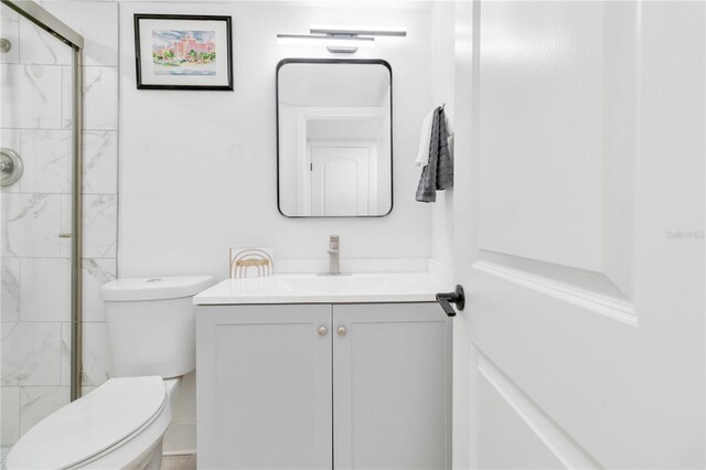 bathroom with vanity, toilet, and an enclosed shower