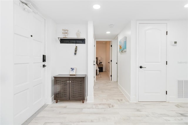 corridor featuring light hardwood / wood-style floors