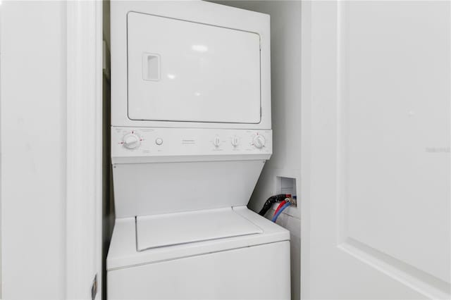 laundry area featuring stacked washer / drying machine