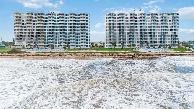 view of property with a view of the beach and a water view