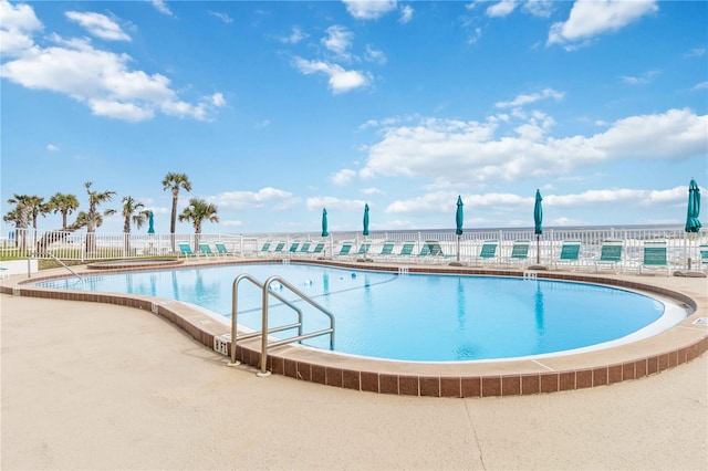 view of swimming pool with a water view