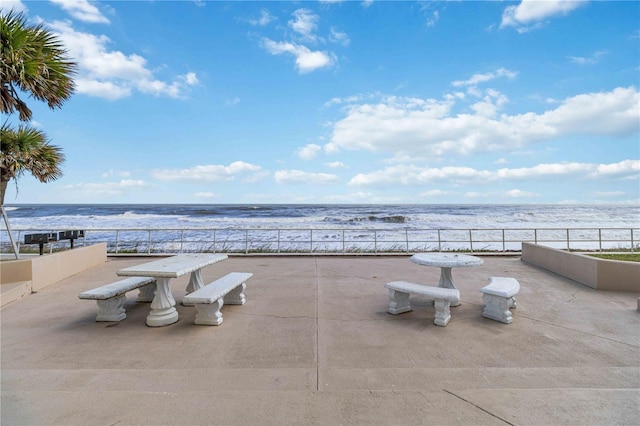 view of patio with a water view