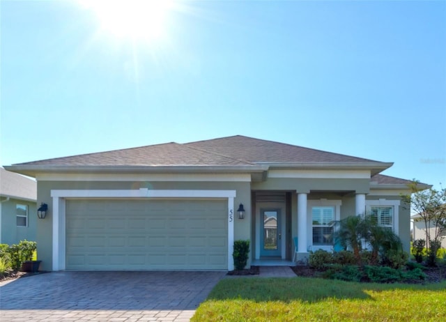 view of front of property with a front yard and a garage