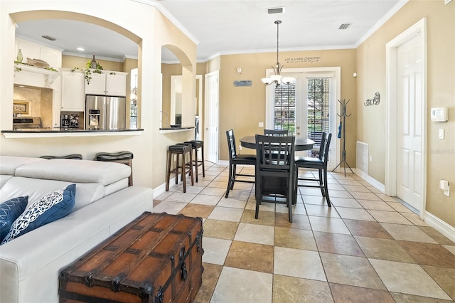 tiled dining room with crown molding and a chandelier