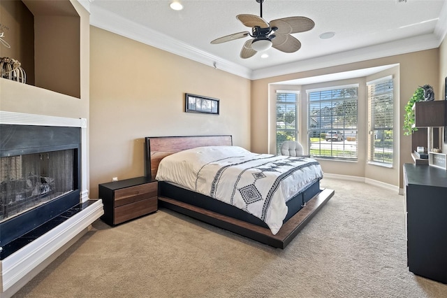 carpeted bedroom featuring ornamental molding, a textured ceiling, and ceiling fan