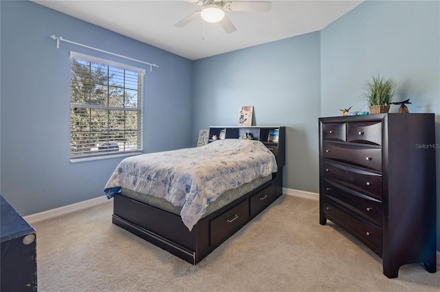 bedroom with light carpet and ceiling fan