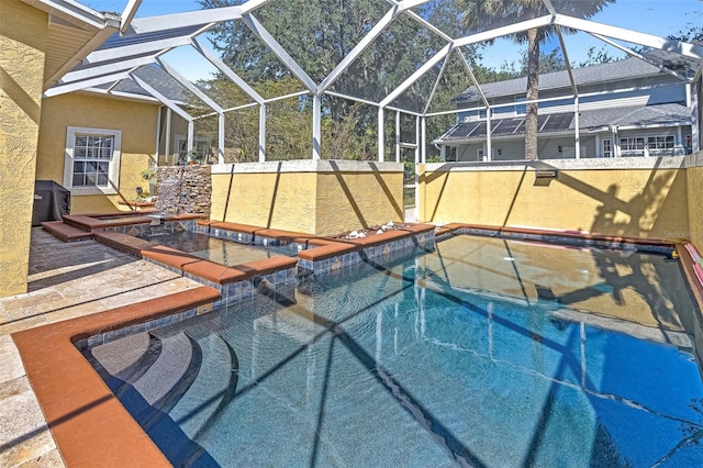 view of pool featuring a jacuzzi, a patio area, and a lanai