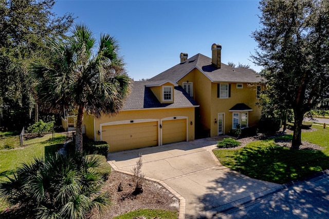 view of front of house with a front yard and a garage