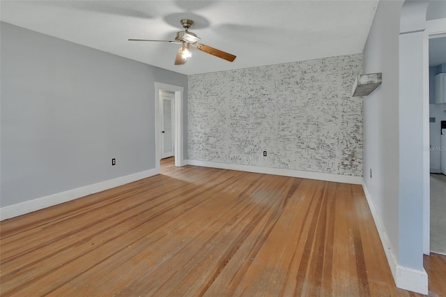 unfurnished room with light wood-type flooring and ceiling fan