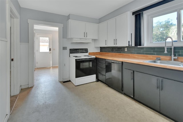 kitchen with a wealth of natural light, black dishwasher, white cabinetry, and white electric stove