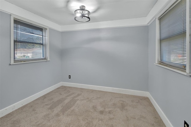 carpeted empty room with a healthy amount of sunlight