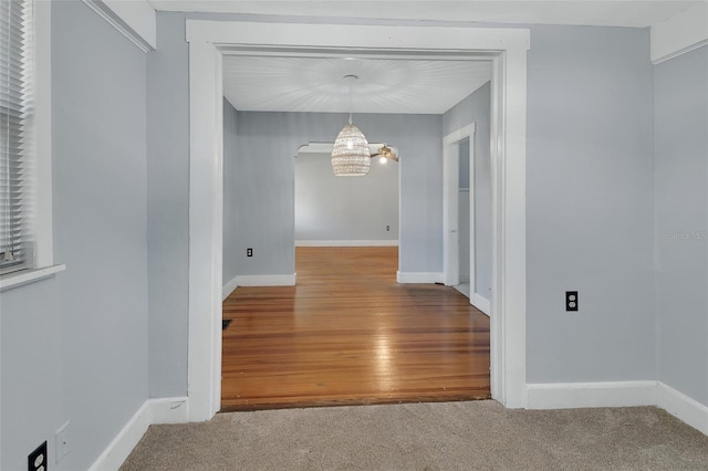 interior space featuring hardwood / wood-style flooring and a chandelier