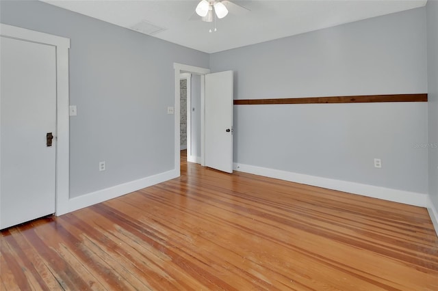 spare room featuring wood-type flooring and ceiling fan