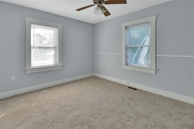 spare room with carpet floors and ceiling fan