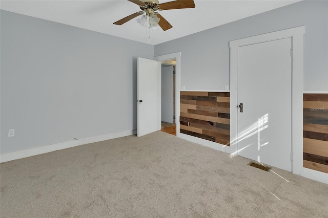 unfurnished bedroom featuring carpet floors and ceiling fan