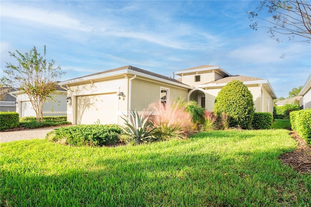 view of front facade with a front yard and a garage