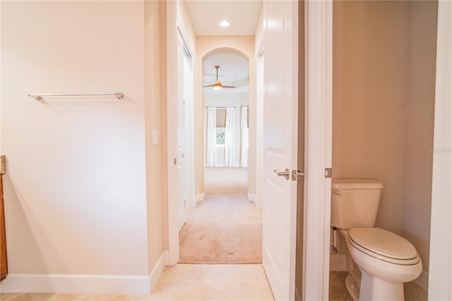 bathroom featuring tile patterned flooring, toilet, and ceiling fan