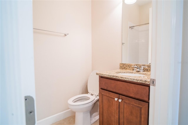 bathroom with vanity, toilet, and walk in shower