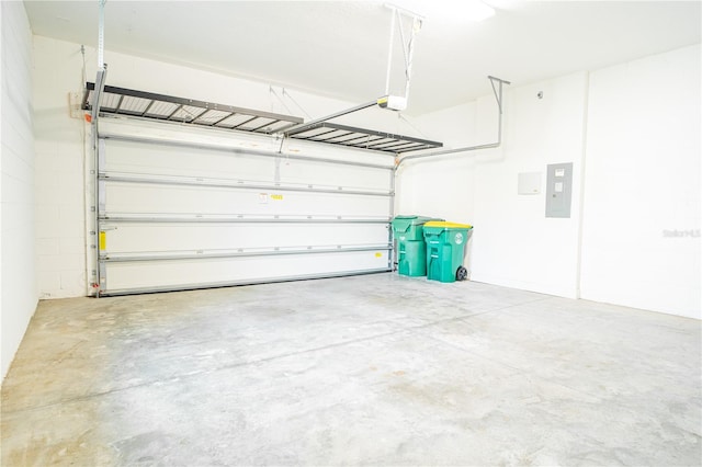 garage featuring electric panel and a garage door opener