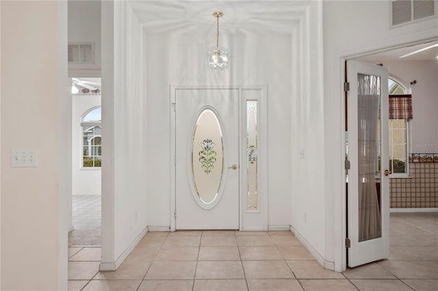 foyer entrance featuring light tile patterned floors and plenty of natural light