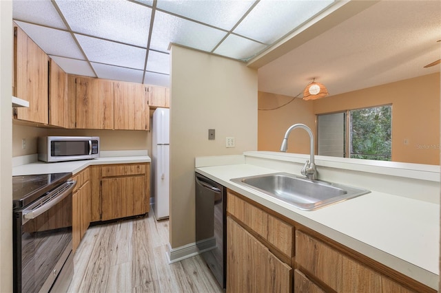 kitchen with sink, appliances with stainless steel finishes, and light wood-type flooring