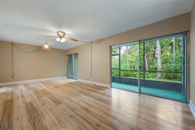 unfurnished room featuring light hardwood / wood-style floors, a textured ceiling, and ceiling fan