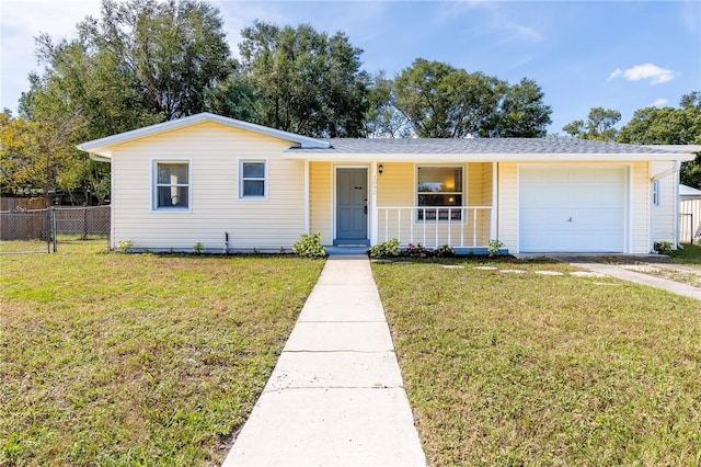 single story home featuring a front yard, a garage, and covered porch