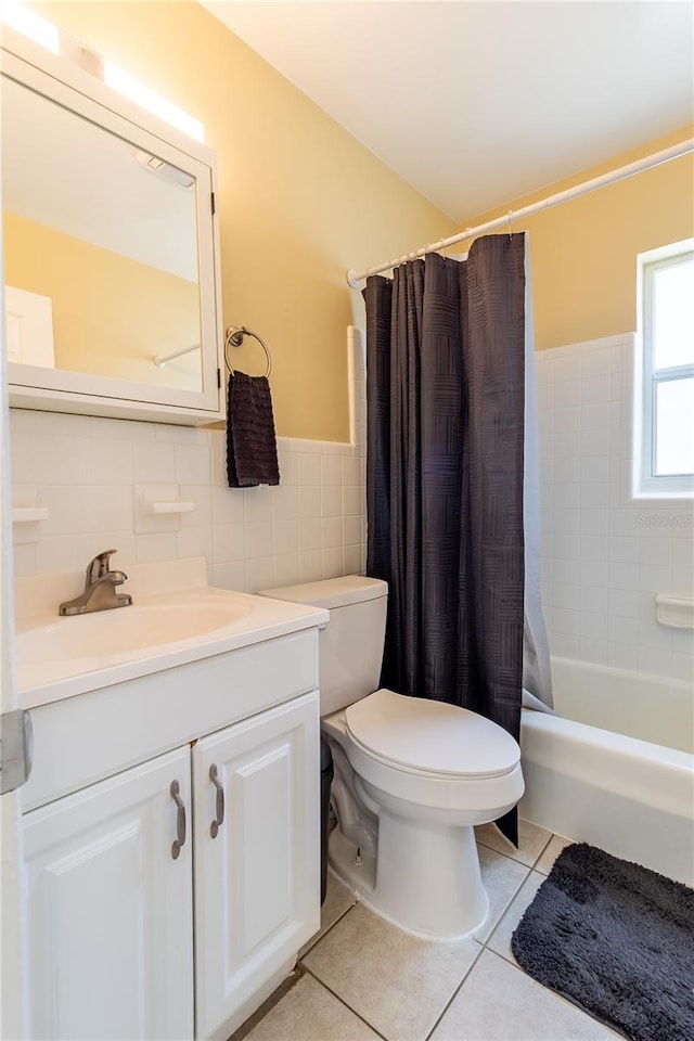 full bathroom featuring tile walls, toilet, vanity, shower / tub combo with curtain, and tile patterned floors