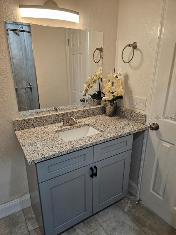 bathroom with vanity and tile patterned flooring