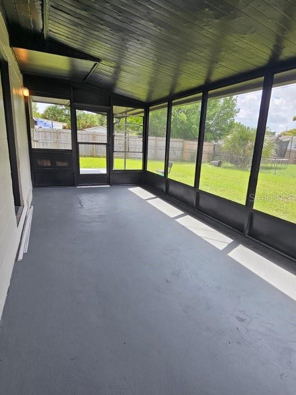 unfurnished sunroom with vaulted ceiling