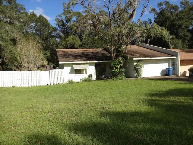 ranch-style house with a front yard and a garage