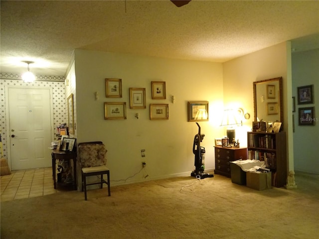 sitting room featuring light carpet and a textured ceiling