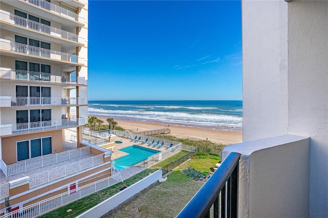 balcony with a beach view and a water view