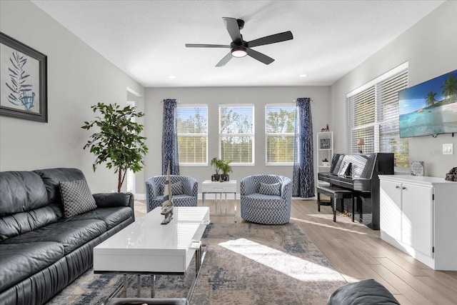 living room featuring light hardwood / wood-style floors and ceiling fan