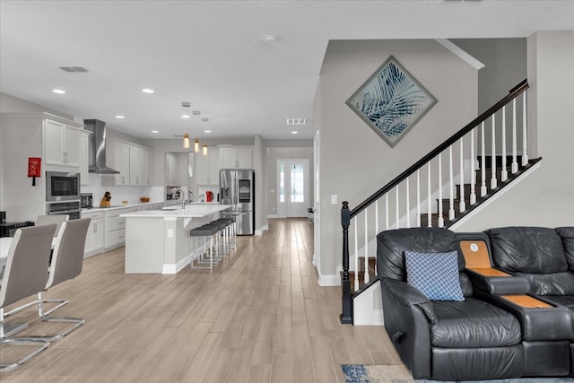 living room featuring light hardwood / wood-style floors and sink