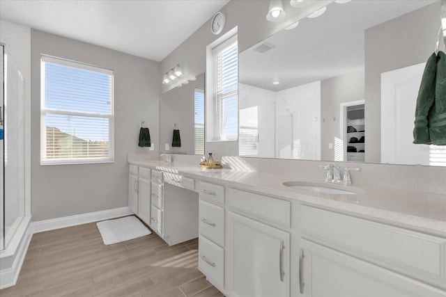 bathroom featuring a shower with door, hardwood / wood-style flooring, and vanity